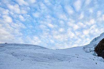 Scenic view of snow covered mountains against sky