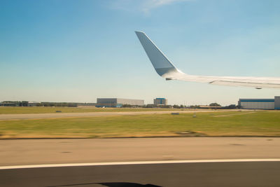 Airplane on runway against sky