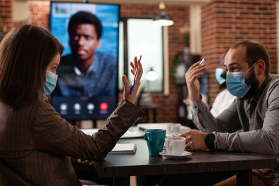 Business colleagues wearing mask during conference meeting