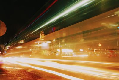 Light trails on road in city at night