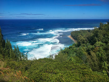 Scenic view at kee beach on the hawaiian island of kauai seen from kalalau hiking trail against sky