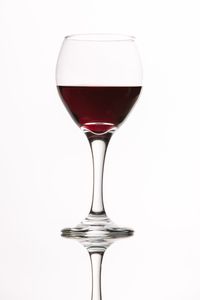 Close-up of wineglass against white background