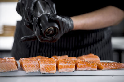 Cropped hand of person preparing food