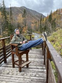 Portrait of young man sitting on bench
