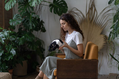 Young girl hold vr glasses prepare to enjoy augmented reality at home garden to relax after work