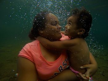 Portrait of happy girl in water