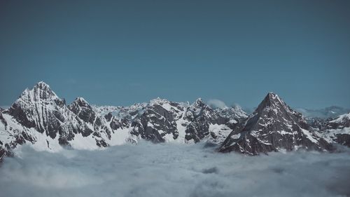 Snowcapped mountains against clear blue sky