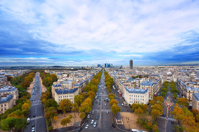 High angle view of city street against cloudy sky