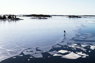 Person ice-skating on frozen water