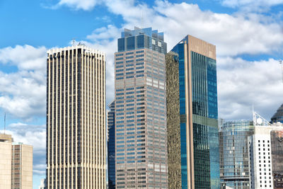 Low angle view of modern buildings in city against sky