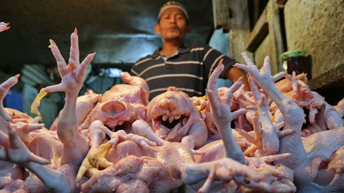 Chicken seller at traditional market in malang, indonesia