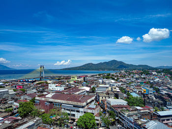 High angle view of buildings and sea against sky