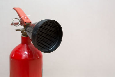 Close-up of red wine bottle against white background