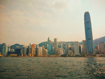 View of city at waterfront during sunset