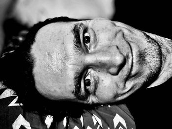 Close-up portrait of dog against black background