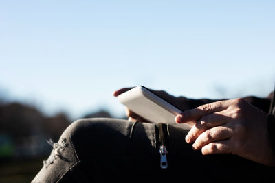 Midsection of man holding book