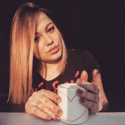 Close-up of woman holding coffee cup