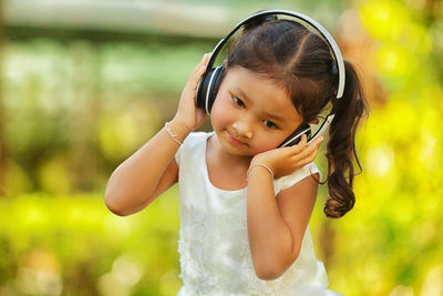 Portrait of cute girl standing outdoors