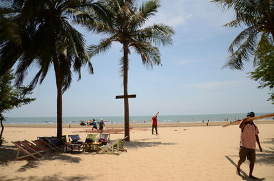 People on beach against sky