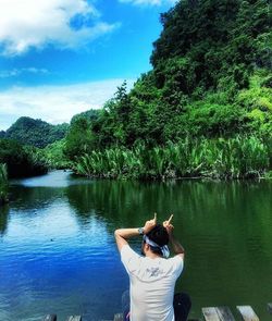 Rear view of man looking at lake