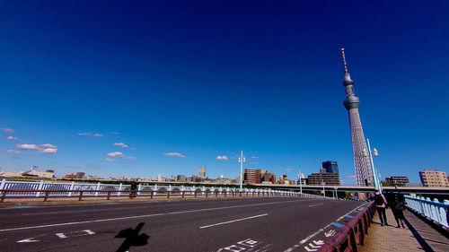 Bridge over buildings against blue sky