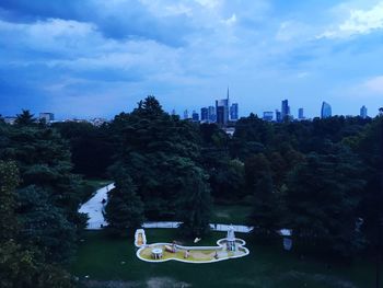 View of buildings in city against cloudy sky