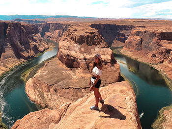 Full length of woman on rocks at shore