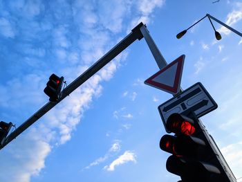 Low angle view of road sign against sky