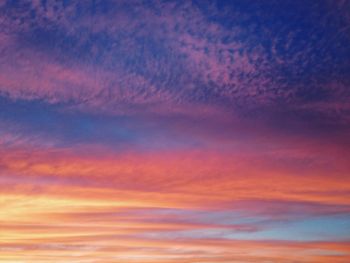 Low angle view of cloudy sky at sunset