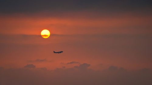 Silhouette hot air balloon against sky during sunset