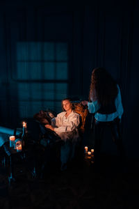 People sitting in illuminated room