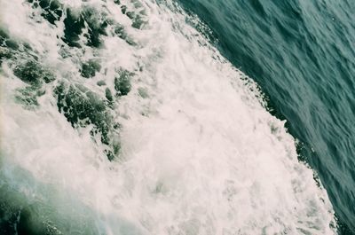 High angle view of waves splashing in sea