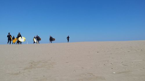 Scenic view of beach against blue sky