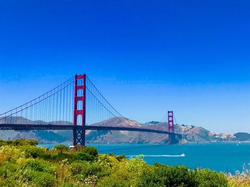 Golden gate bridge over bay against blue sky