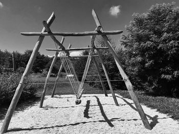 Black and white shot of an old wooden swing