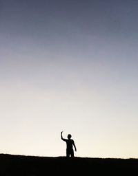 Silhouette woman standing against trees