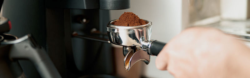 Cropped hand of woman holding coffee