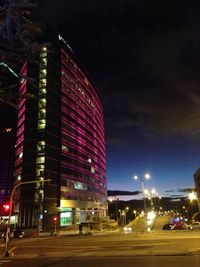 Low angle view of illuminated building against sky at night