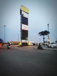 Traffic on road in city against sky