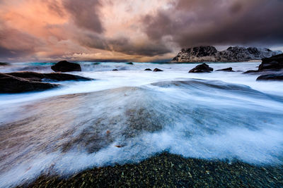 Scenic view of frozen sea against dramatic sky