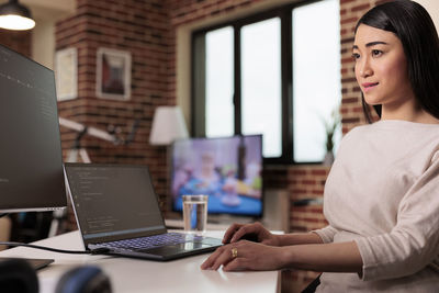 Young woman using laptop on table