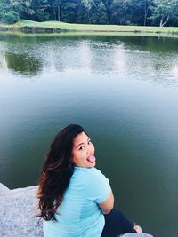 Portrait of woman against lake