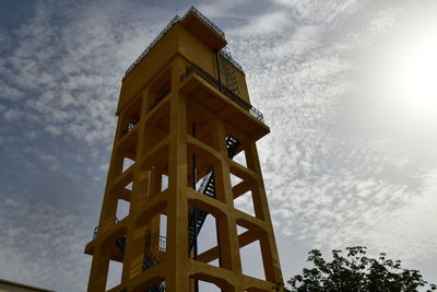 Low angle view of building against cloudy sky