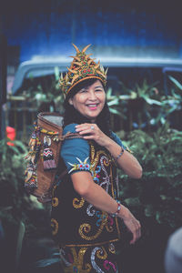 Portrait of young woman wearing hat while standing outdoors