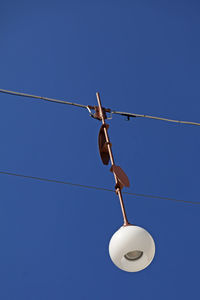 Hanging street lamp in gavle with blue sky