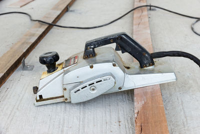 High angle view of electric plane on wooden plank