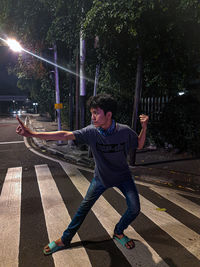 Full length of man fighting on road at night