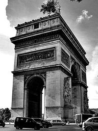 Low angle view of building against cloudy sky