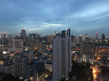 Illuminated cityscape against sky