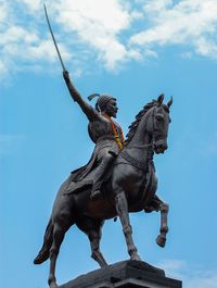 Low angle view of statue against sky